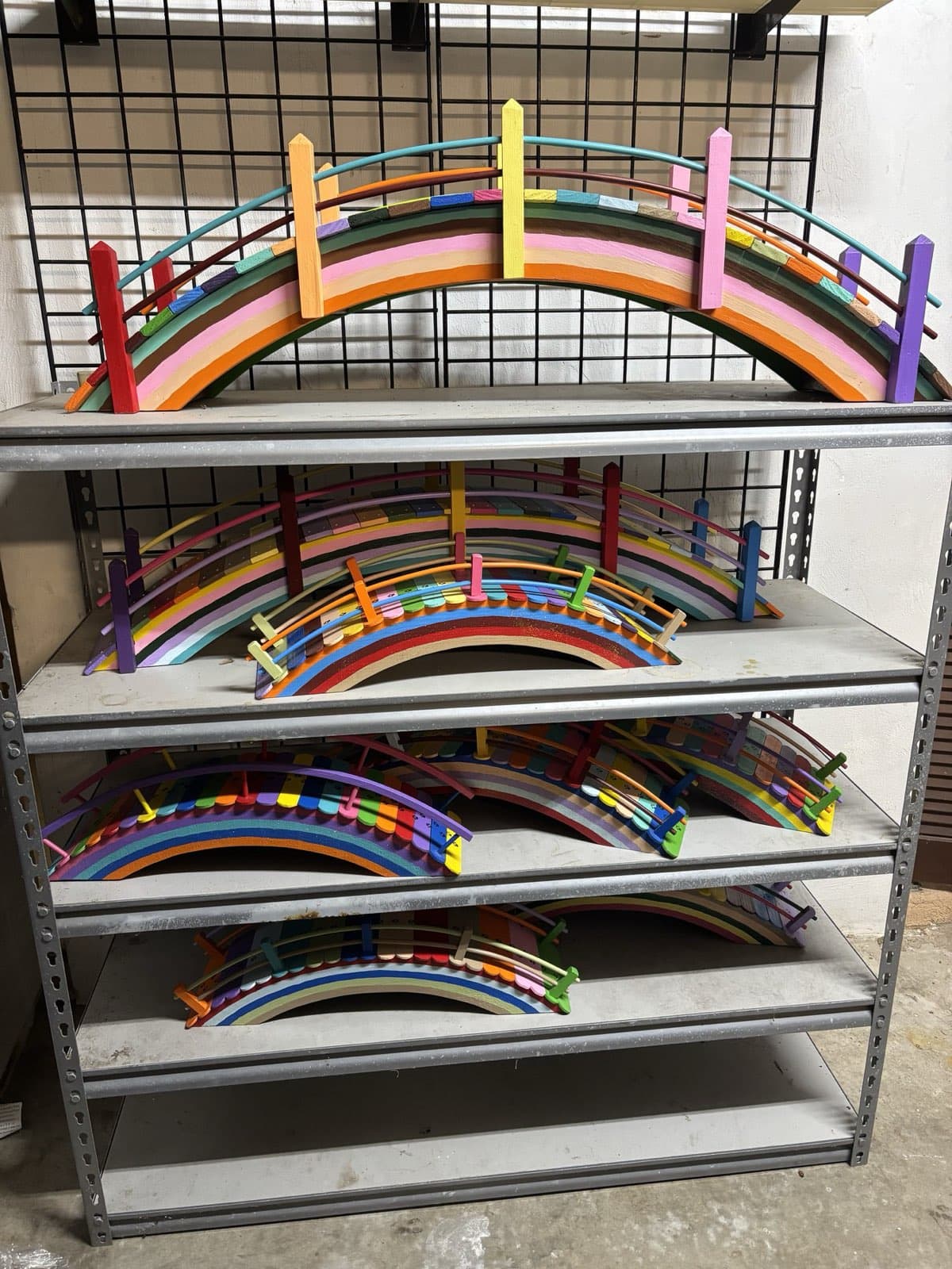 Several of Paul Allabaugh's finished Rainbow Bridges lined up on a shelf
